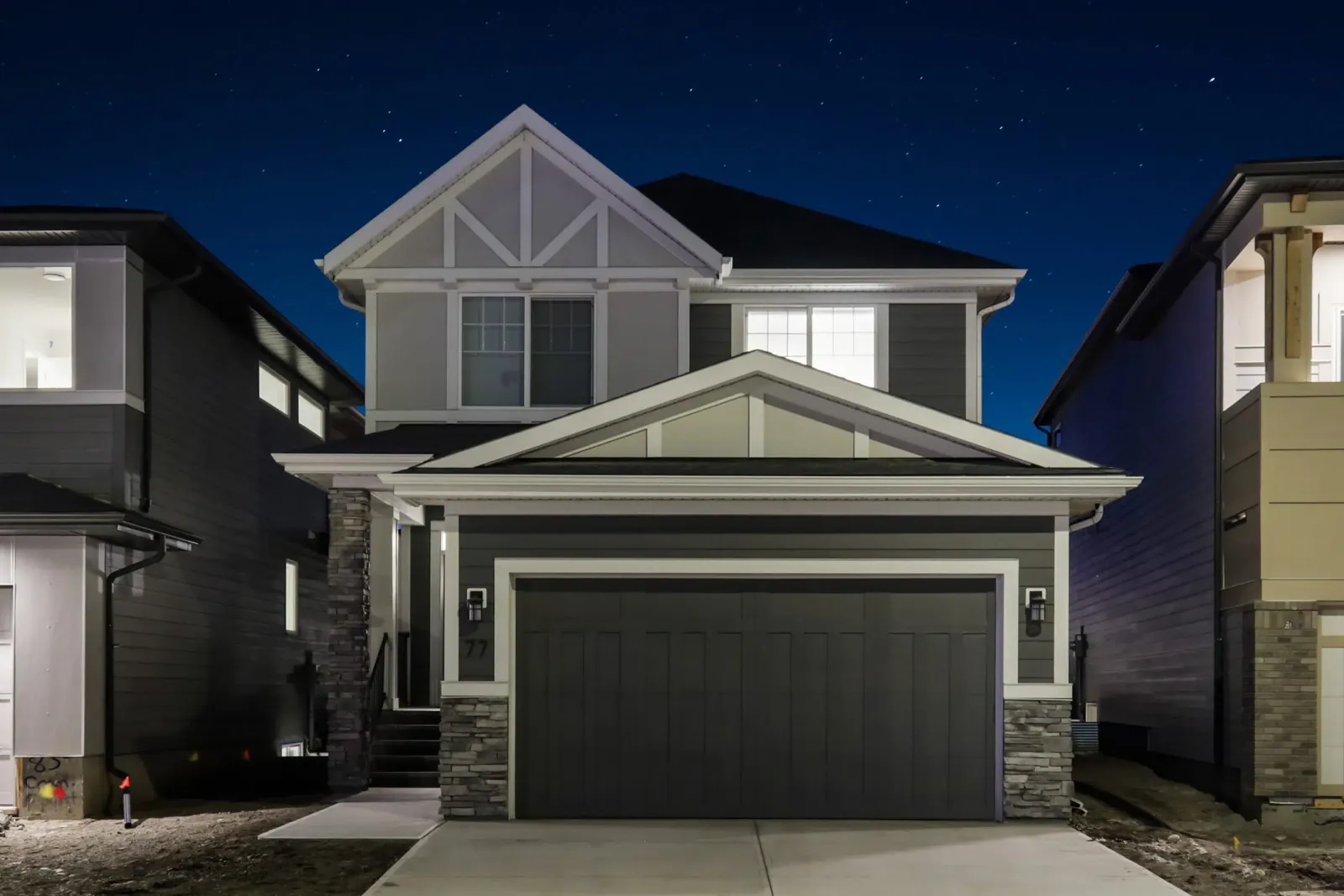 Two-story home at dusk with its roofline lights switched off